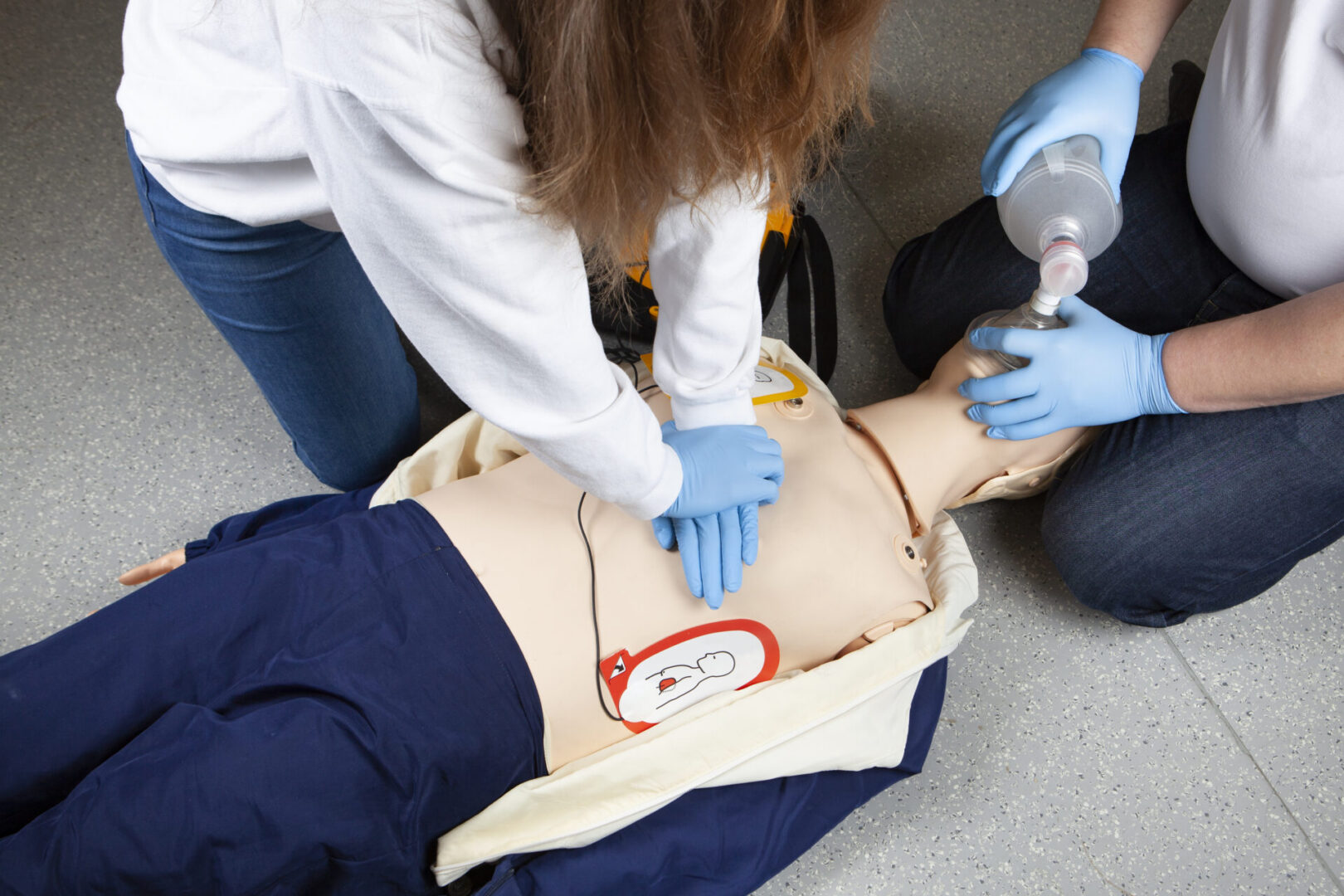 Performing a cardiopulmonary resuscitation (CPR) and using an AED (automated external defibrillator), Bag-Valve-Mask (BVM) Ventilation. Demonstration on a CPR dummy